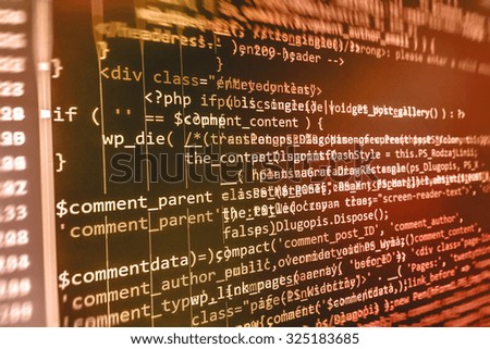 Software developer programming code on computer. Abstract computer script source code. Shallow depth of field, selective focus effect. Code text written and created entirely by myself.