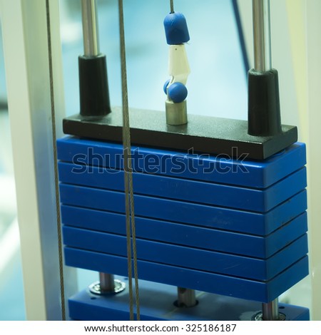 Closeup photo of iron blocks part of power sports equipment blue color for building muscles on body in training hall, square picture