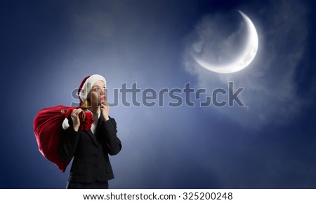 Thoughtful Santa woman with red gift bag on back