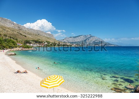 Beautiful scenic beach close to Omis in Croatia Royalty-Free Stock Photo #325222988