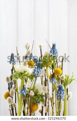 Floral arrangement with anemones and grape hyacinths (blue muscari). Copy space, postcard.