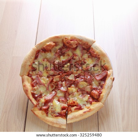 Pizza vegetarian with mushroom and pineapple on wood table