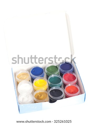 Open colorful cans of gouache paint in box isolated