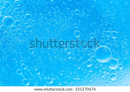 Air bubbles in the water background.Blue tone.