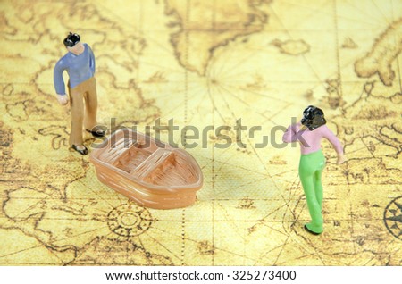 mini model of a man woman on a old world map