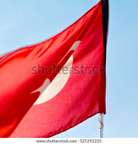 waving flag in the blue sky  tunisia     colour and wave