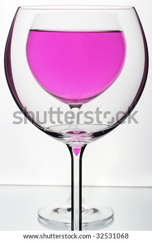 Glasses on mirror with gray background.