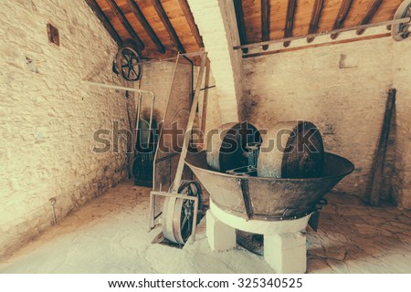 Ancient olive oil production machinery, stone mill and mechanical press Royalty-Free Stock Photo #325340525