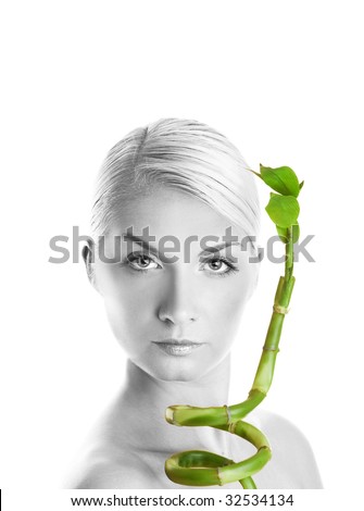 Monochrome picture of a beautiful young woman with a bamboo plant