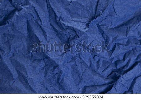 Abstract crumpled paper background Top view. Grunge photo background. Blue colors.