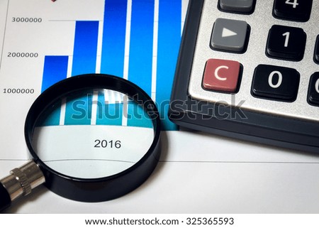 Selective focus magnifier and calculator on chart focus text 2016.