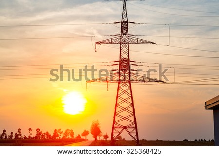 Beautiful sunset over the powerlines on the field