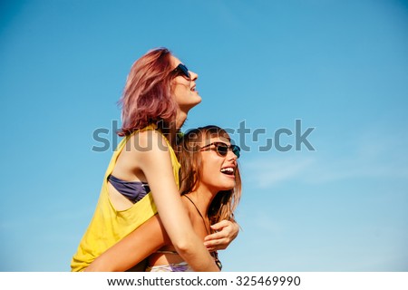 Two Cheerful Females Having Fun Outdoors