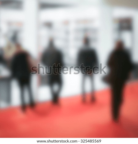 People walking, generic background. Intentionally blurred post production.