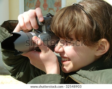 teenager girl shooting with digital camera