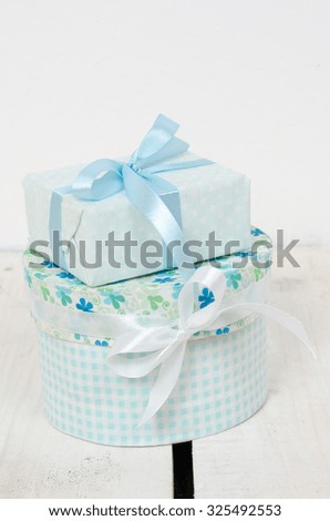 Two gifts stand on white wooden floor
