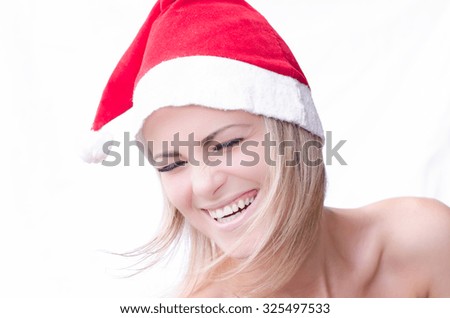 One beautiful funny young new year woman with blond hair in red santa claus hat for christmas standing in studio on white background, horizontal picture