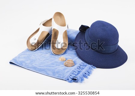 Bright beach accessorize isolated on white. White flip flops and blue hat