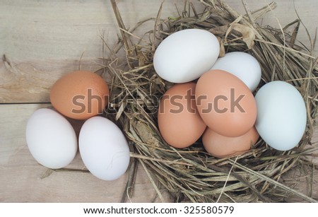 Still Life- eggs in a nest of hay. On the old wooden floor.