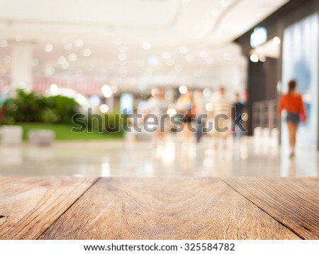 Wood floor and blurred shopping mall background