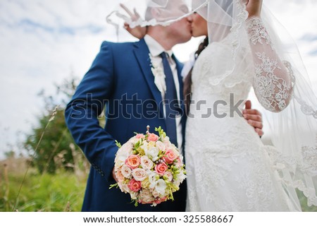 kissing wedding couple close up