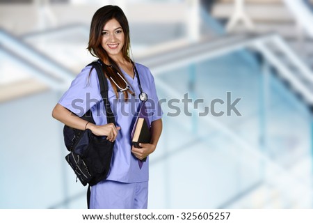 Minority nursing student with her books going to class