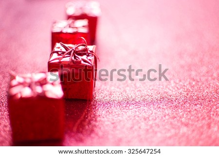 Red gift boxes and red glitter background