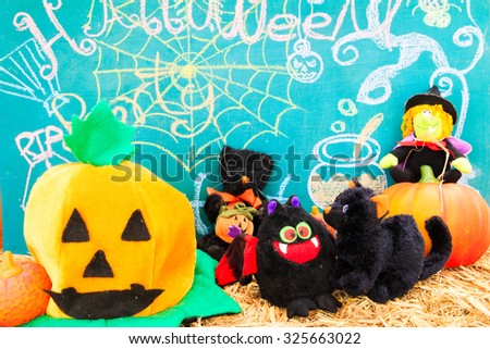 Halloween pumpkin dolls on a bale of hay 