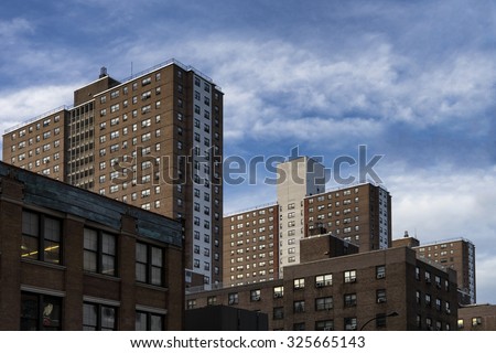Urban cityscape dominated by public housing complexes, along 9th Avenue. Chelsea, Manhattan. Royalty-Free Stock Photo #325665143