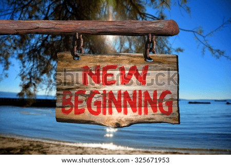 New beginning sign with beach blurred background