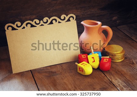 image of jewish holiday Hanukkah and wooden dreidels (spinning top) with empty card for adding text