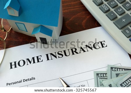 Home insurance form and dollars on the table. Royalty-Free Stock Photo #325745567