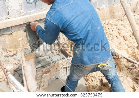 Placing concrete by hand.Selective focus. Very shallow Depth of Field, for soft background.