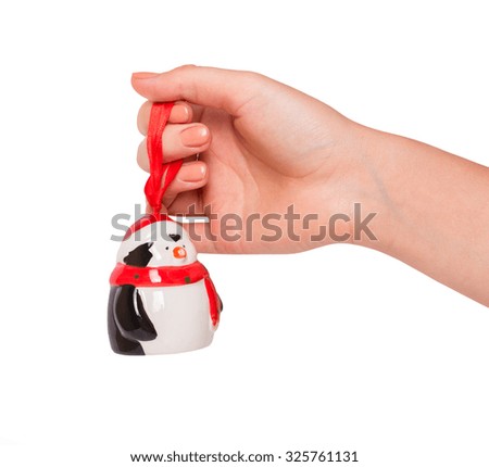 hand with Christmas toys on a white background 