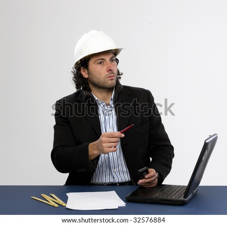 Young architect at work with laptop isolated