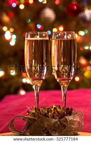 Christmas glasses of champagne on the background of colorful bokeh. Merry Christmas and Happy New Year. New Year's EveNew Year's Eve