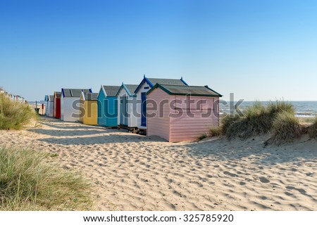 Colourful beach huts at Southwold on the Suffolk coast Royalty-Free Stock Photo #325785920