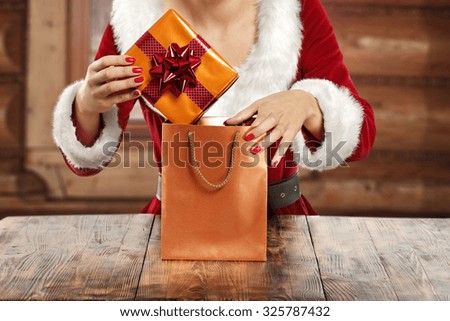 golden bag and gift and woman with table 