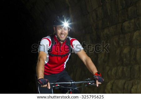 Portrait Mountainbiker with headlamp Royalty-Free Stock Photo #325795625