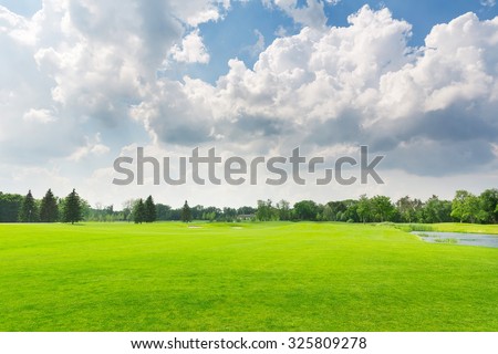 Panorama view of beautiful summer park with cloudy sky