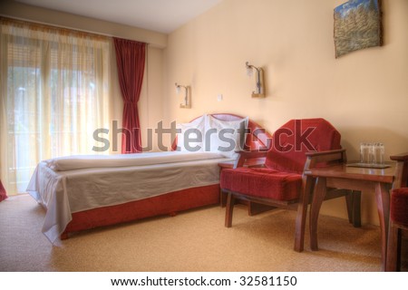 hotel bedroom in colors red and brown empty