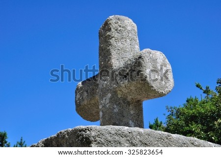Cross of granite and blue sky on the Brittany coast in France