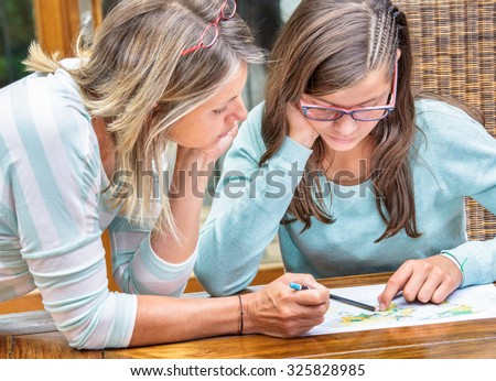 pretty student girl taking courses with beautiful blond teacher Royalty-Free Stock Photo #325828985