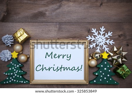 Golden Picture Frame With Green Tree And Christmas Decoration Like Gifts, Balls Snowflake And Fir Cone. English Text Merry Christmas. Brown Wooden And Rustic Retro Background As Christmas Card.