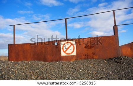 No fire and smoking sign on rusty board. Shot in Ukraine