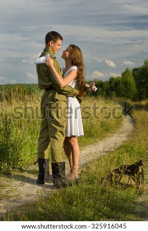 Happy girl meets a soldier. Return of the Soviet soldier in uniform of World War II home