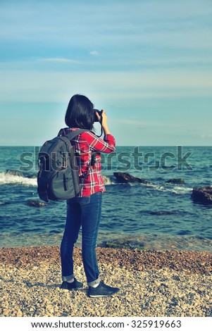 hipster girl photographing sea. Vintage photo