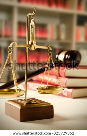 Scale of Justice. Law composition with gavel on books in background