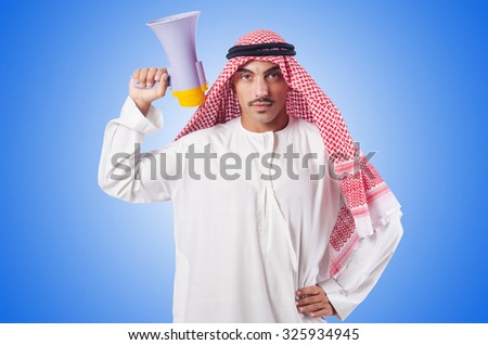 Arab man shouting through loudspeaker Royalty-Free Stock Photo #325934945