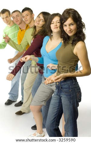 Group of 6 teenagers standing in line. They're looking at camera and dancing.